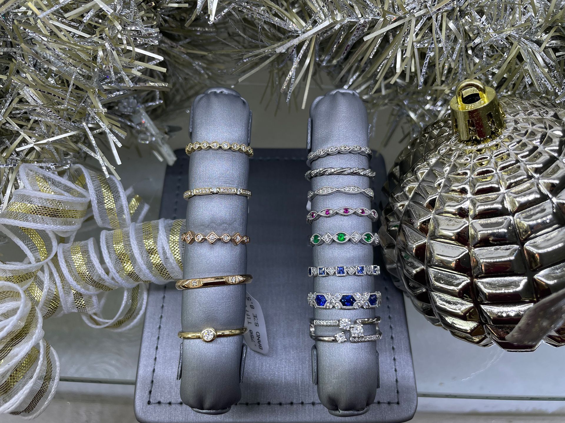 Rings displayed on gray stands in a jewelry store