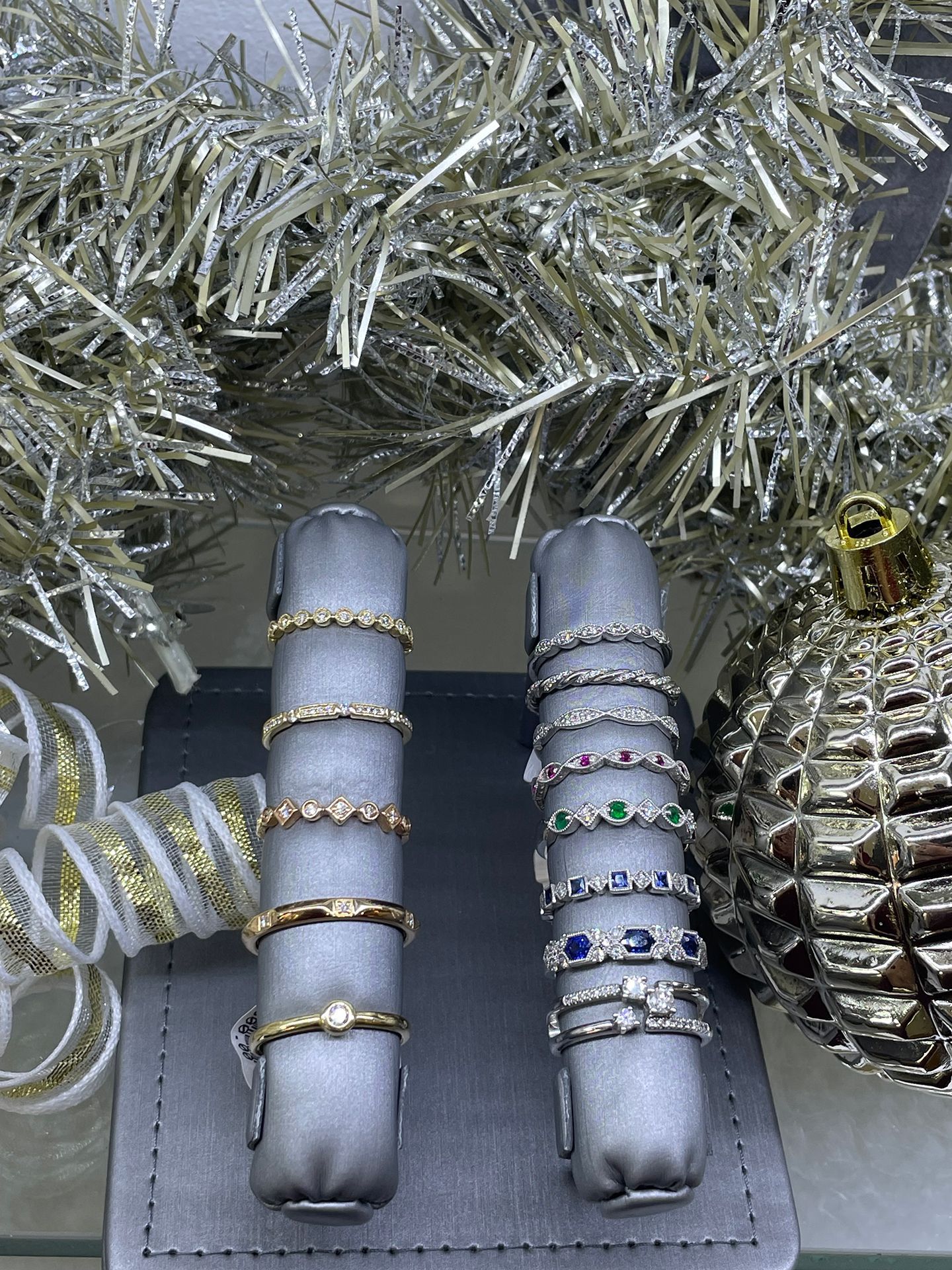 Two ring displays with multiple gemstone and gold rings