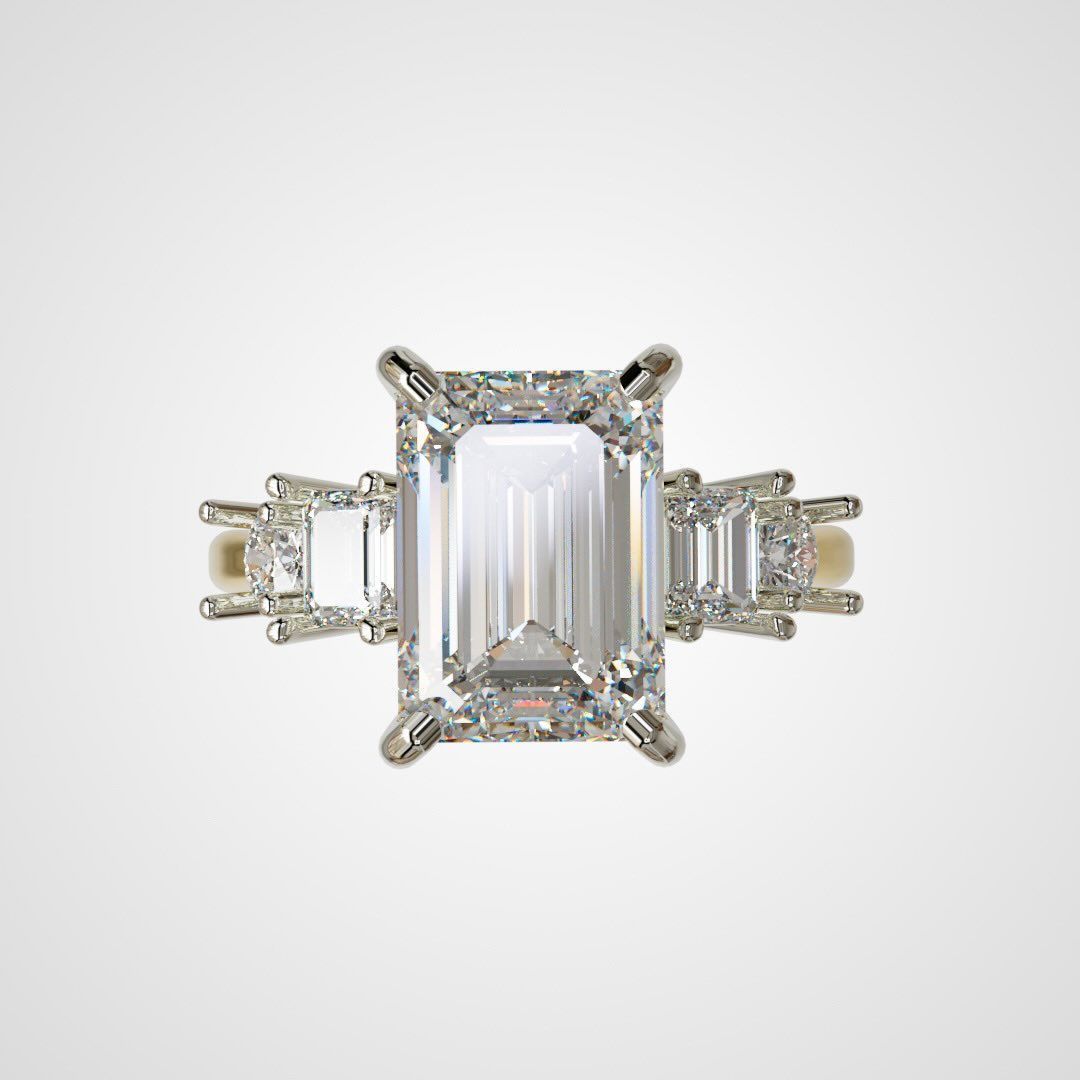 Diamond ring with an emerald-cut center stone and smaller rectangular side stones, set in white gold.