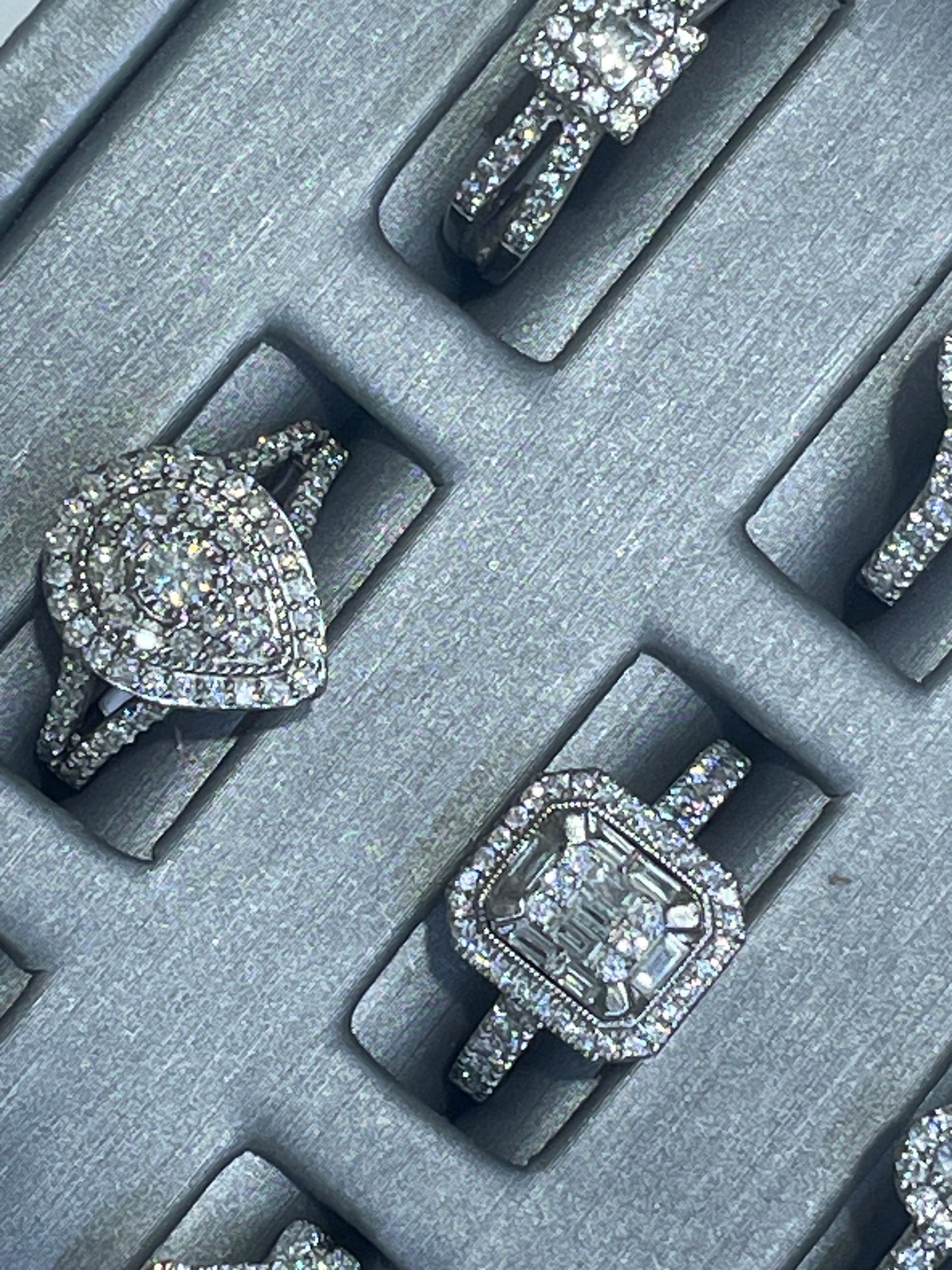 Diamond rings displayed in a black velvet jewelry tray