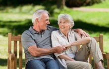Happy senior couple sitting on a bench