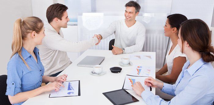 Two men shaking hands during a business meeting
