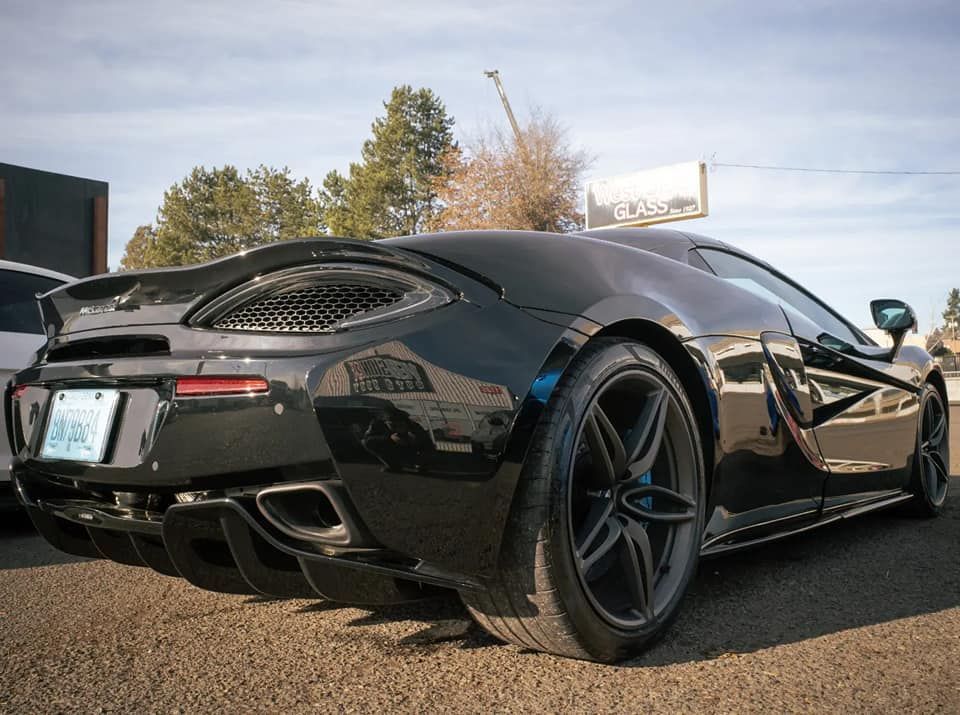 Black sports car parked outdoors.