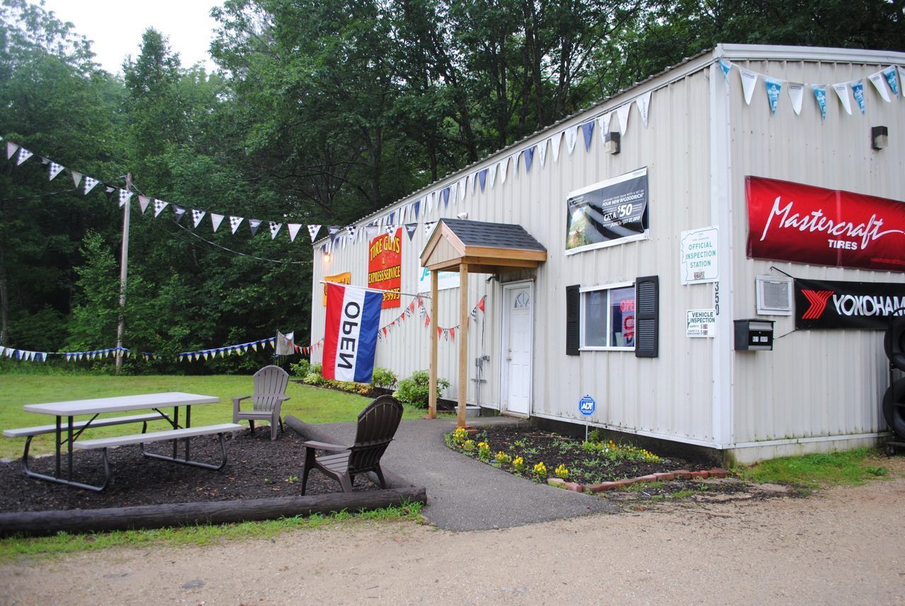 A white building with a red sign that says mastercraft
