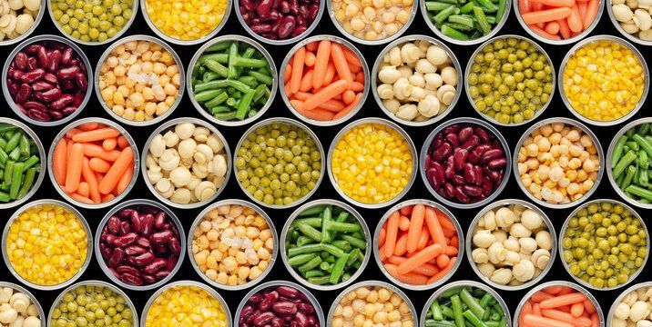 Rows of canned vegetables, including peas, beans, corn, carrots, and mushrooms, arranged in a grid.