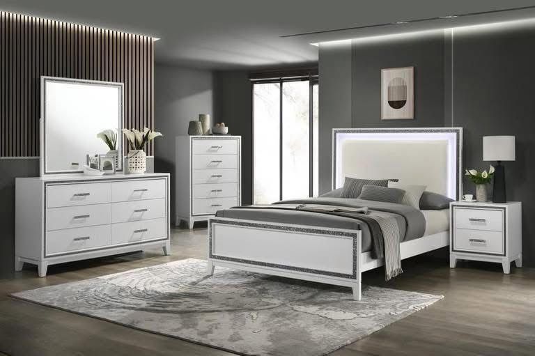 Modern gray bedroom with white bed, dressers, lamp, and rug