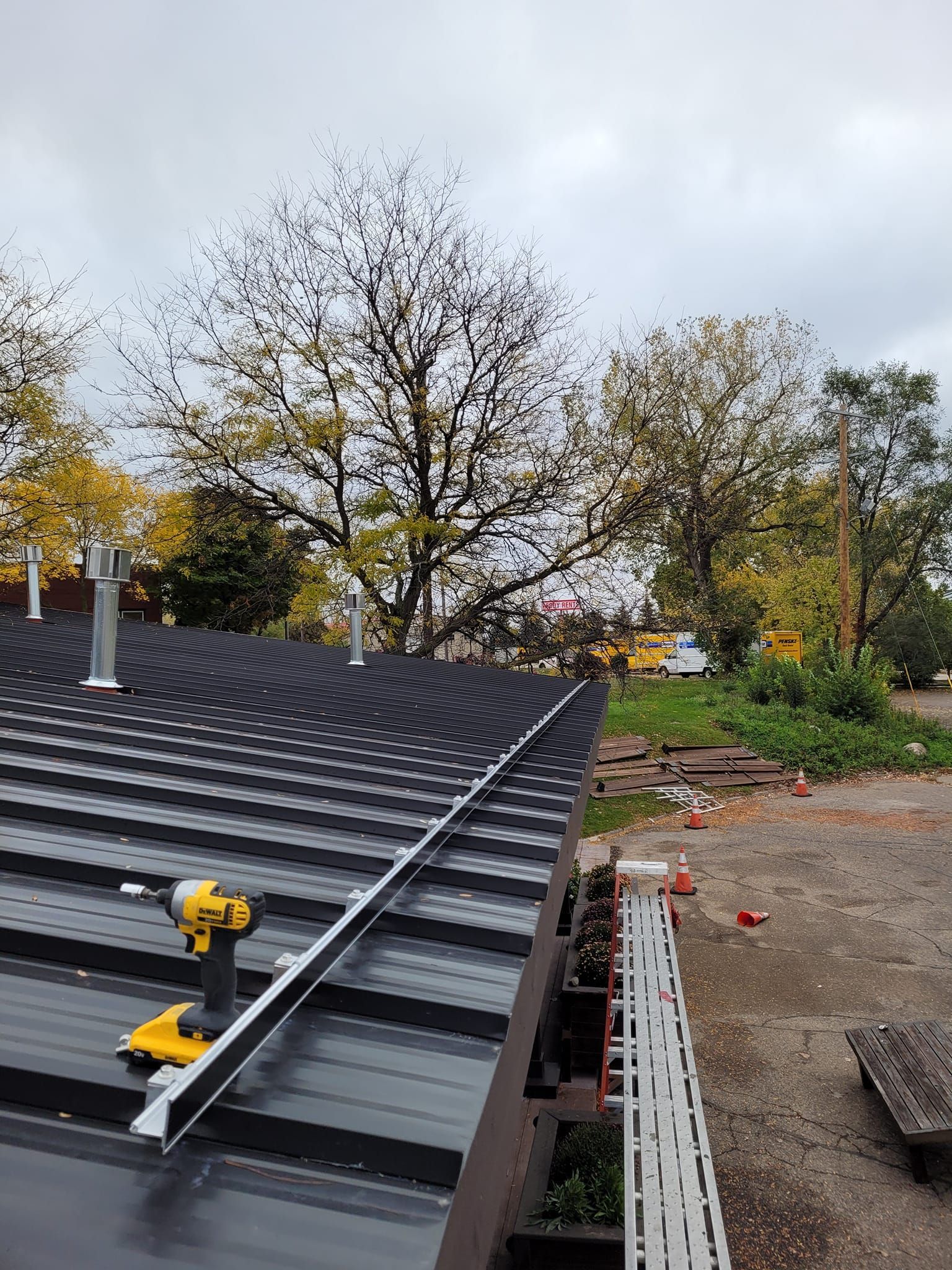 A drill is sitting on top of a roof.