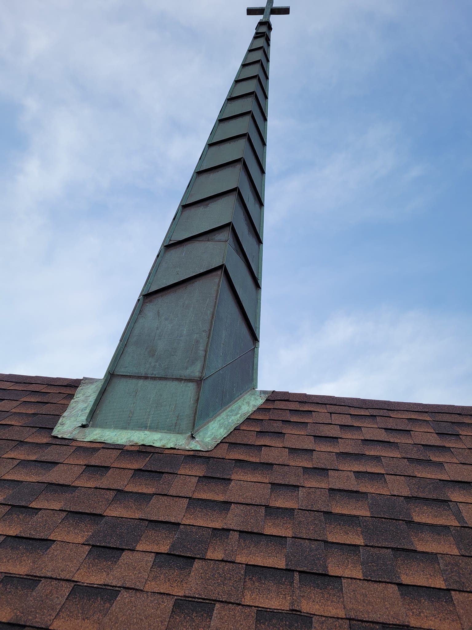 A church steeple with a cross on top of it.