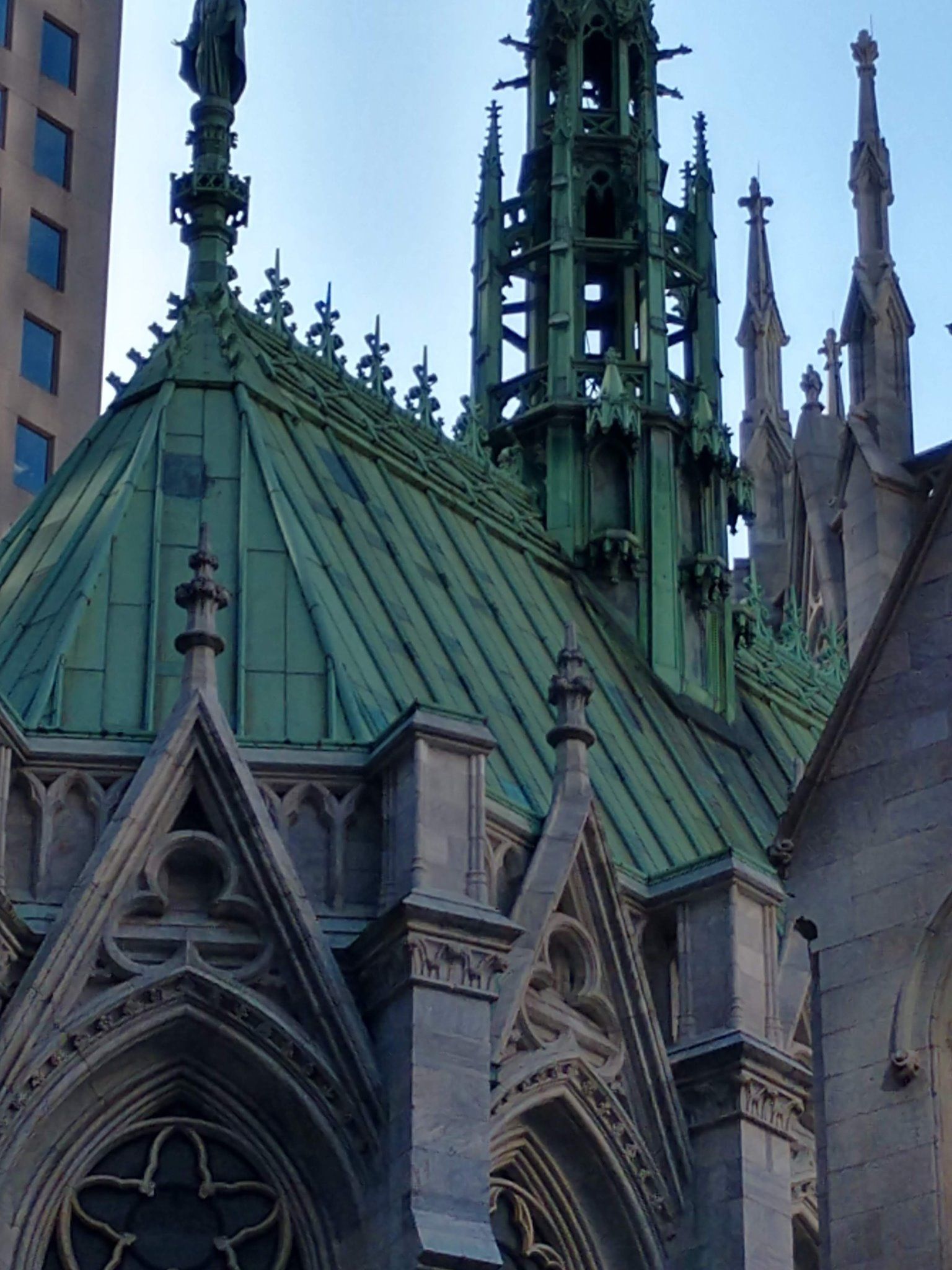 A very tall building with a green roof
