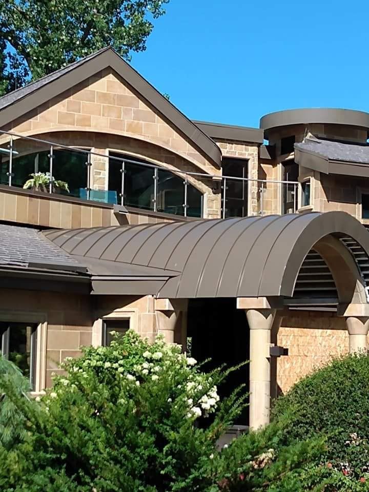A large house with a curved roof and a balcony