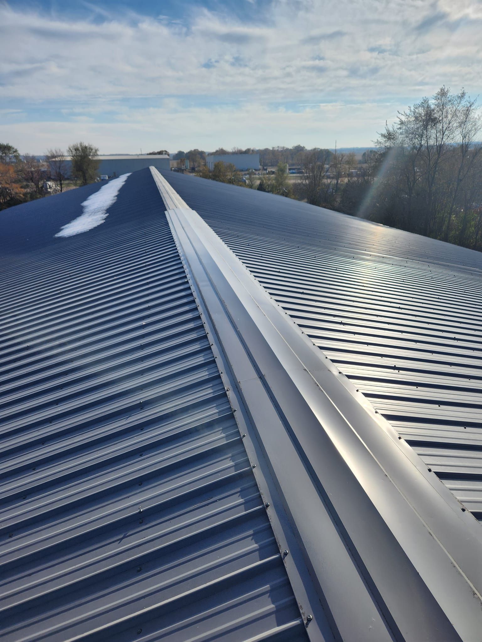 A close up of a roof with a blue sky in the background