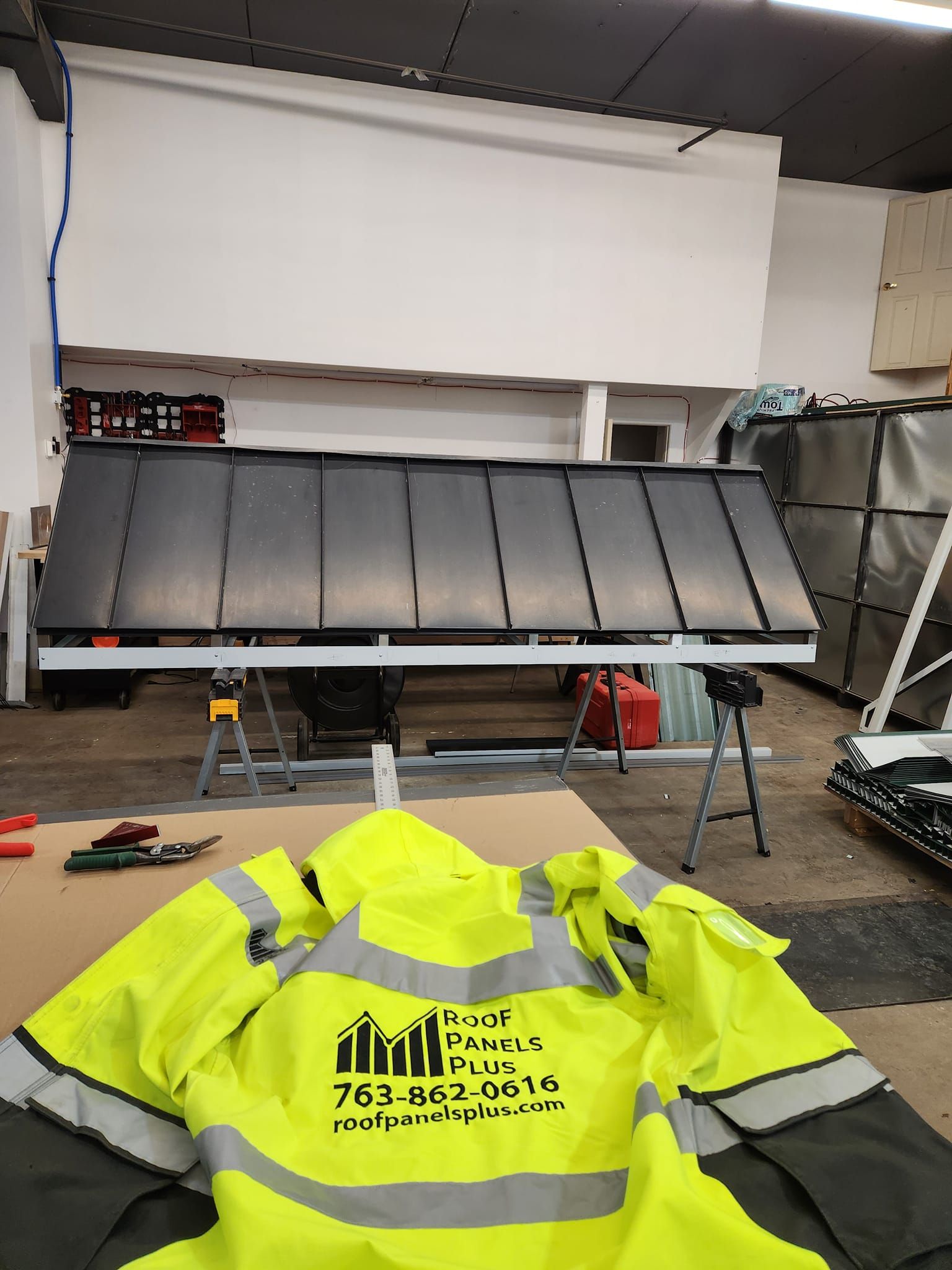 A yellow high visibility jacket is sitting on a table in a warehouse.