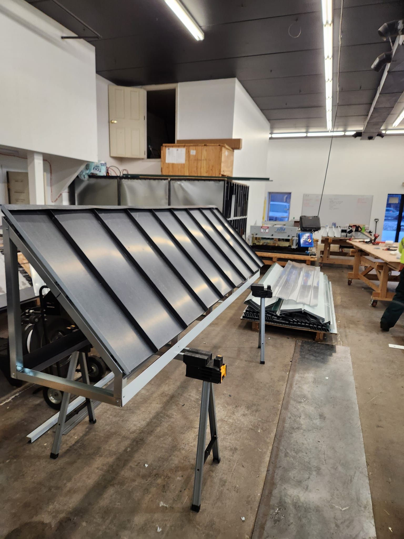 A large piece of metal is sitting on a table in a workshop.