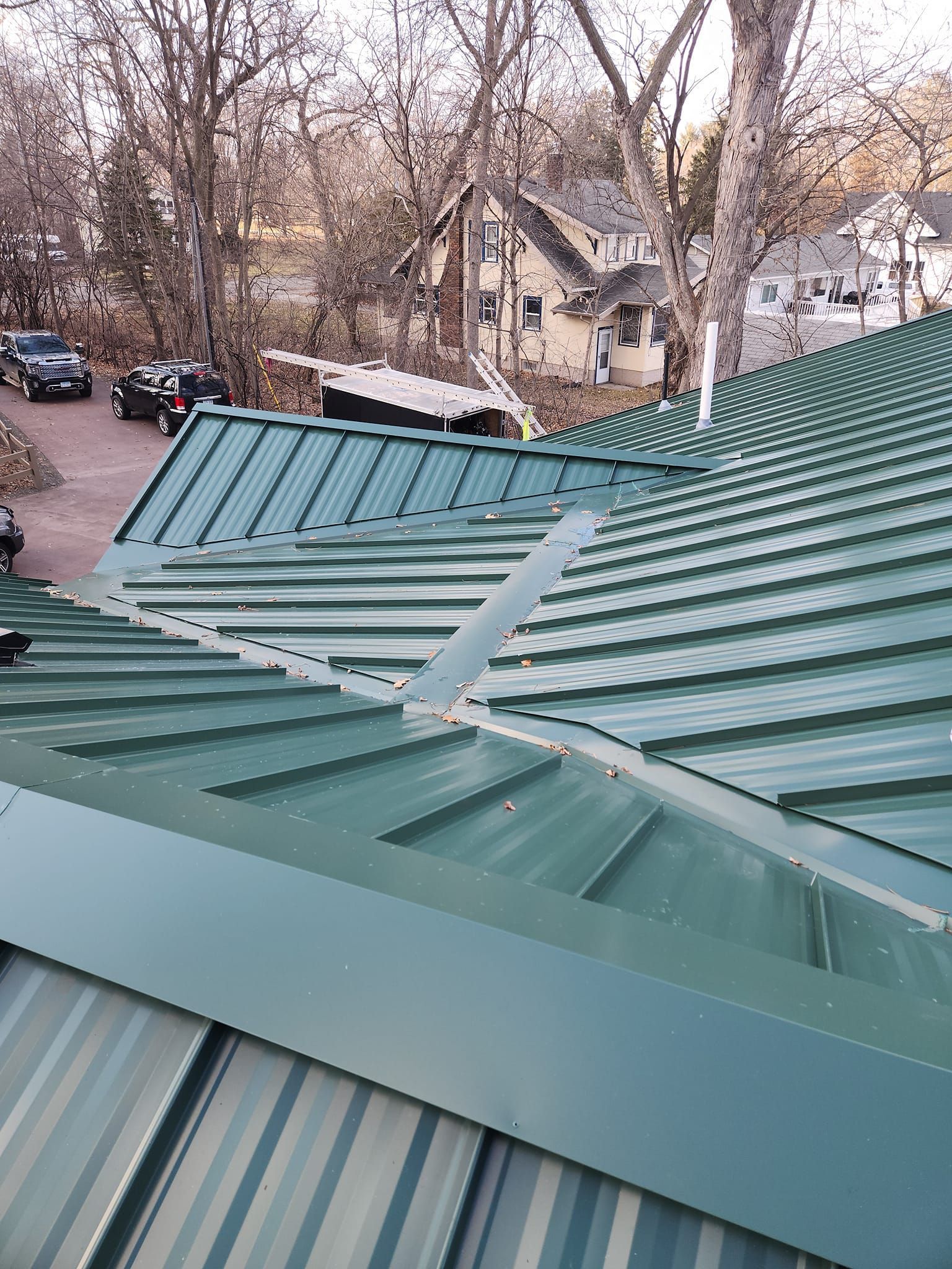 A green metal roof is sitting on top of a building.