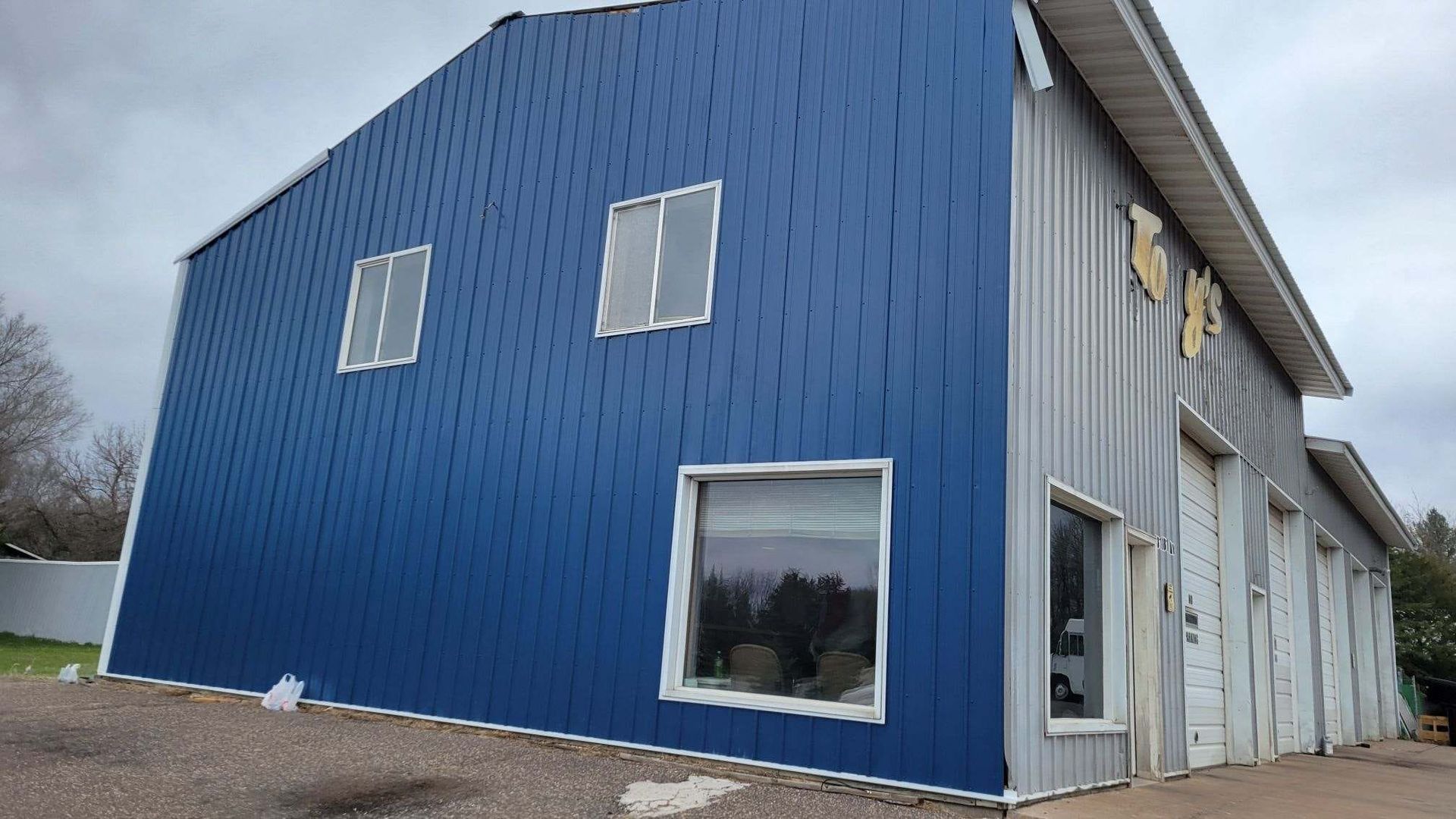A large blue building with a lot of windows is being built.