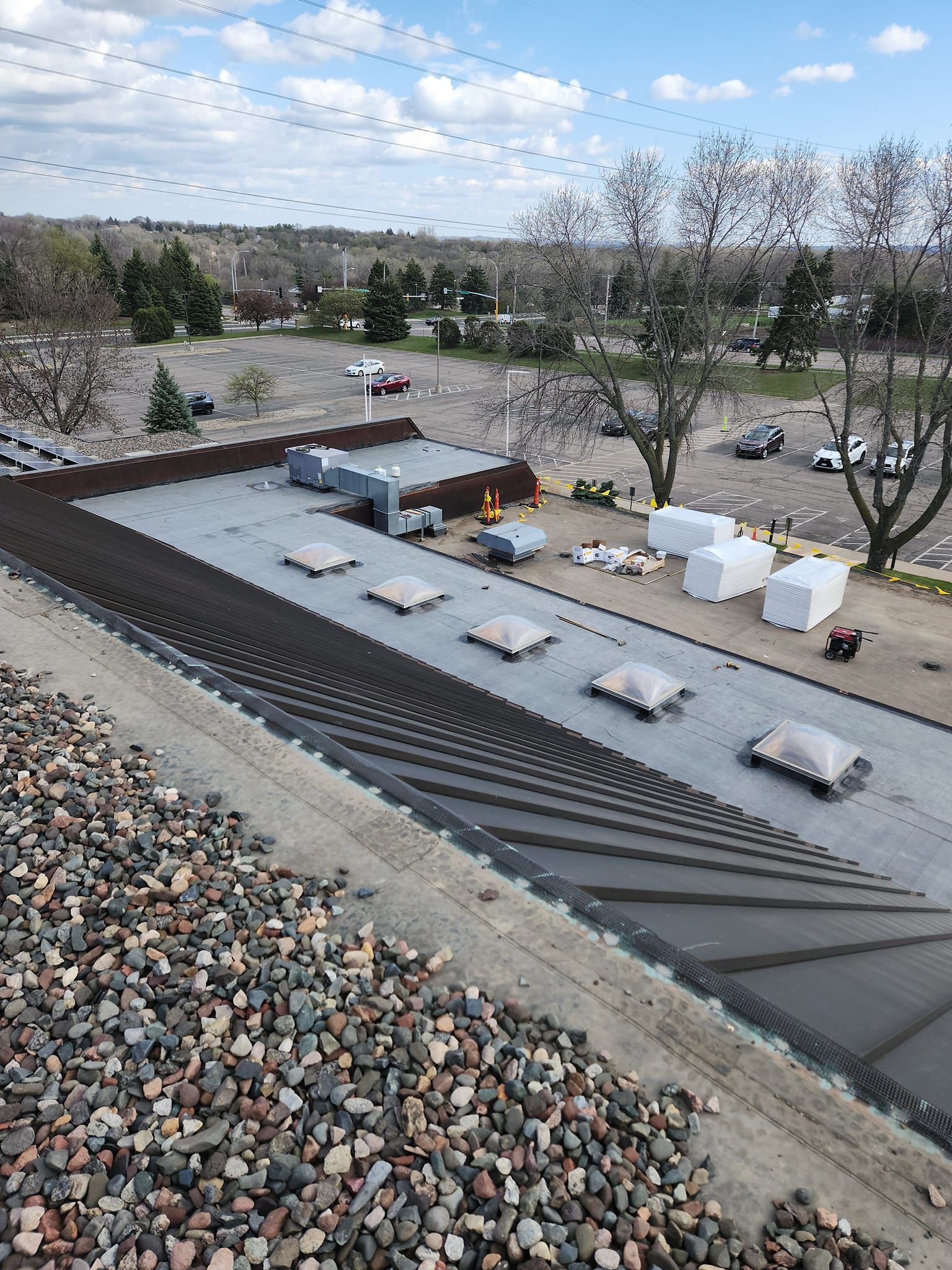An aerial view of a roof with a lot of rocks on it.