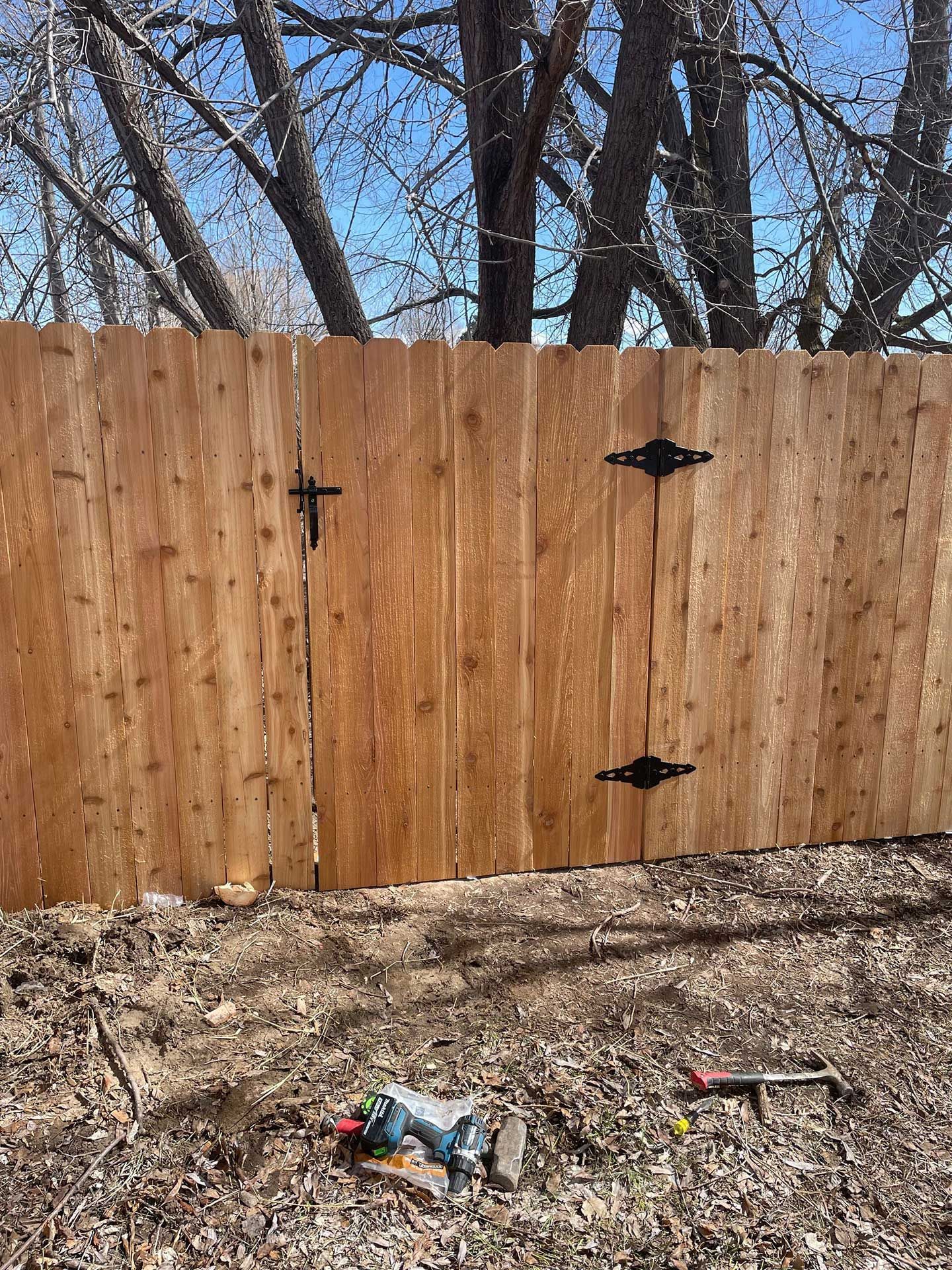 wooden fence with black hinges and latch