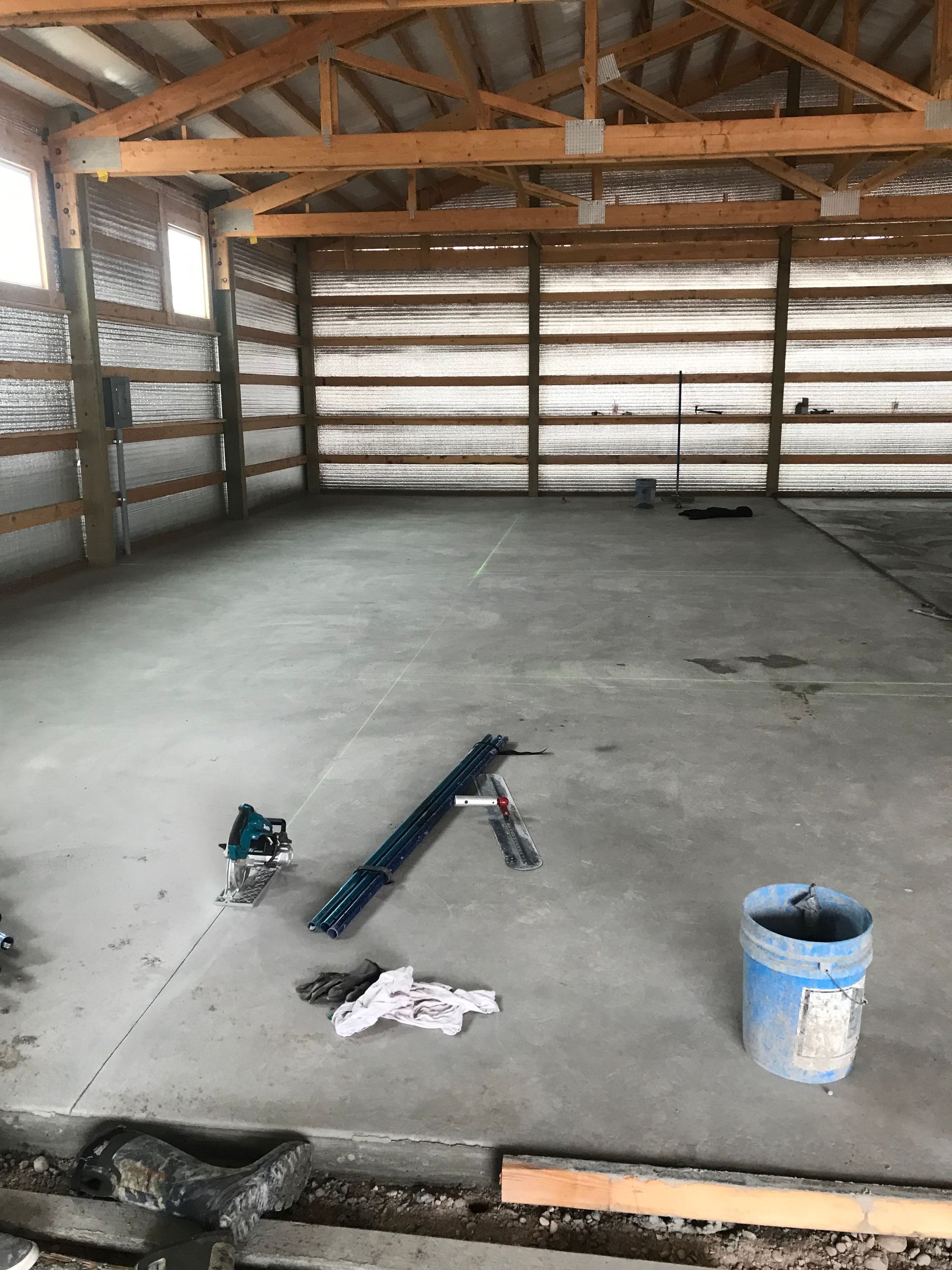 A bucket of concrete is sitting on the floor