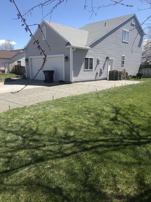A house with a garage and a driveway in front of it