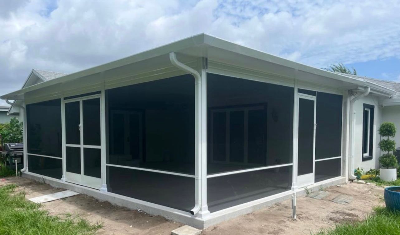 A house with a screened in porch and a white roof.