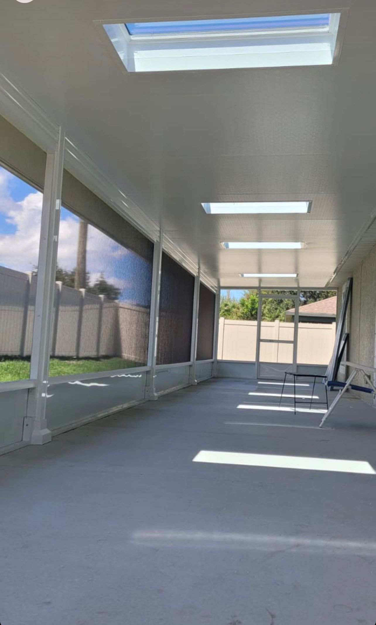 A covered porch with a skylight and a ladder.