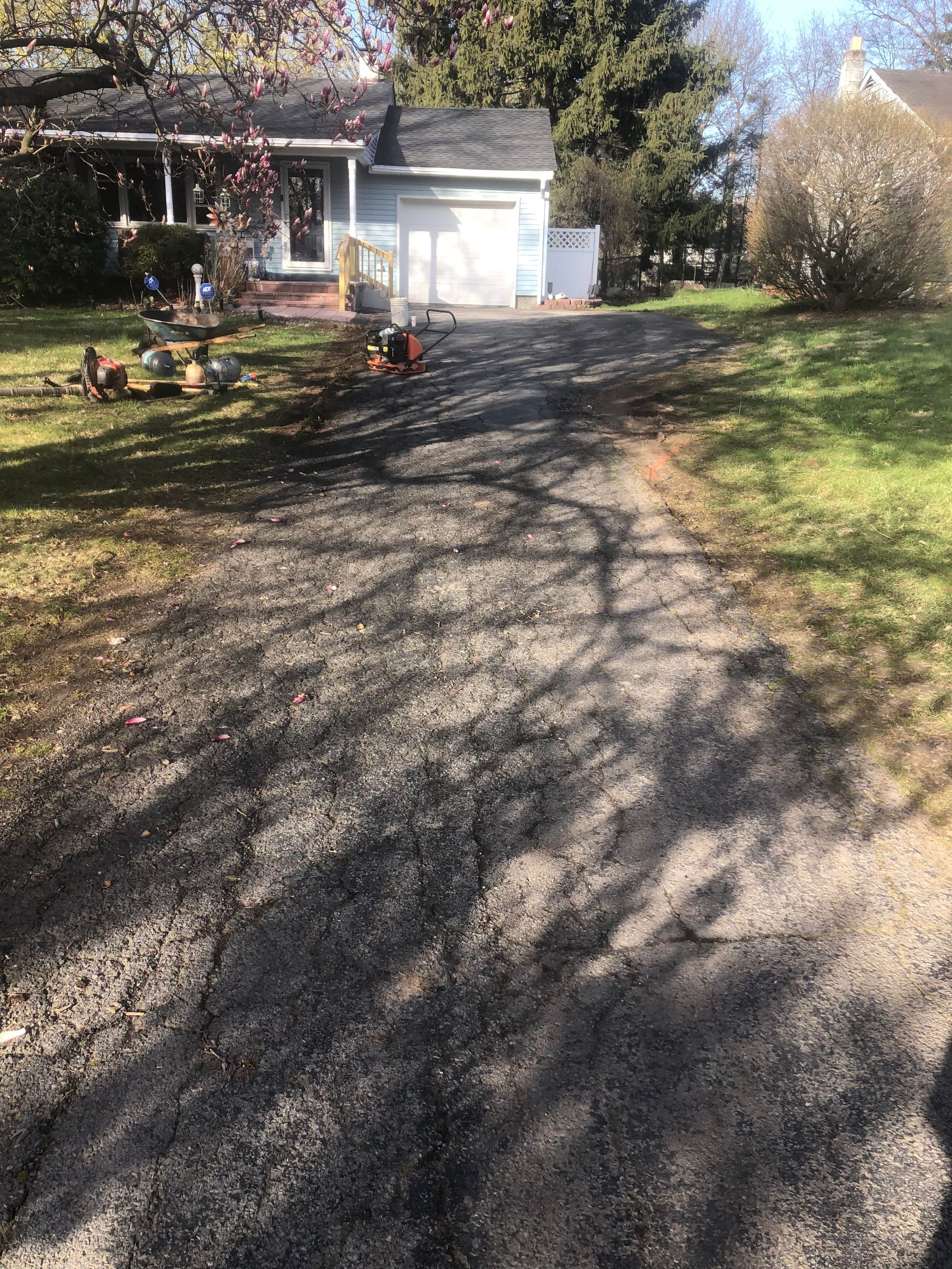 After driveway condition leading to a house with a garage.