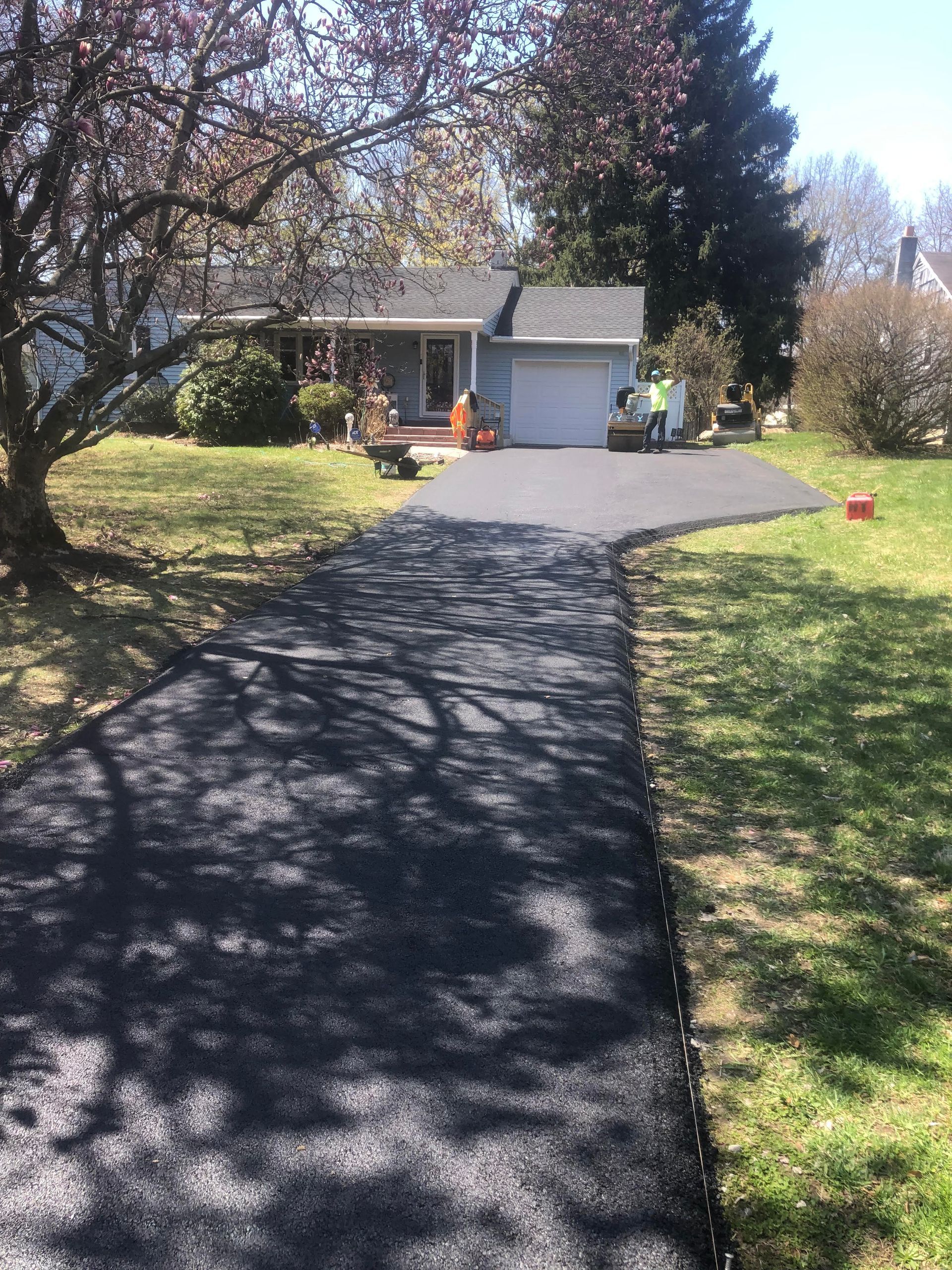 After driveway condition leading to a house with a garage.