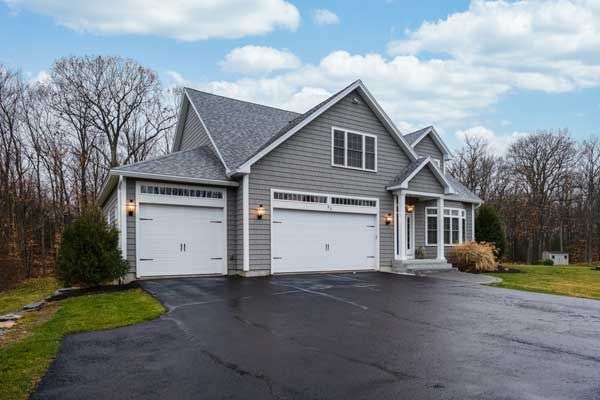 A large house with garage doors and a driveway