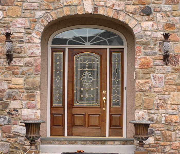 The front door of a stone building with a wooden door