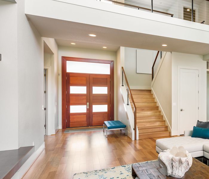 A living room with stairs leading up to the second floor