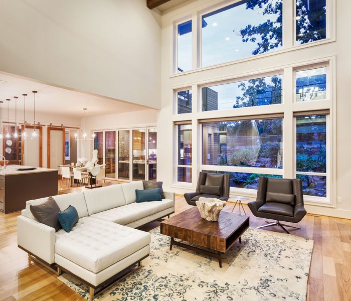 A living room filled with furniture and lots of windows.