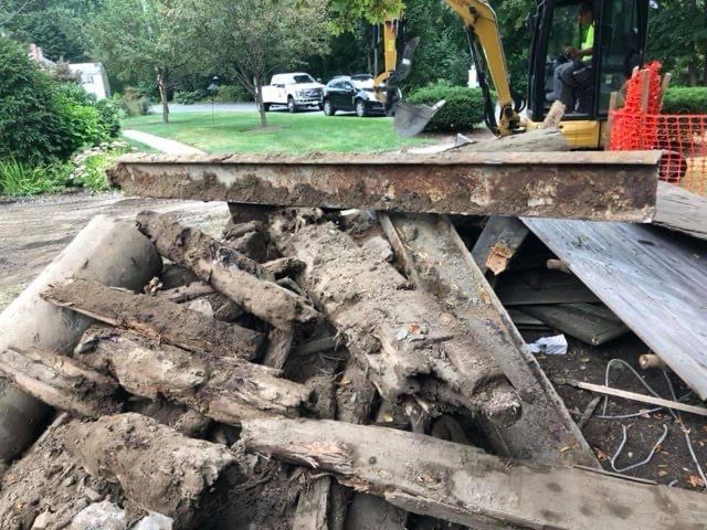 A pile of wood is sitting on top of a pile of dirt.