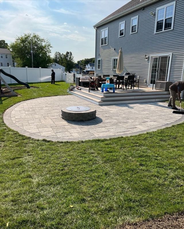 There is a fire pit in the middle of the patio.