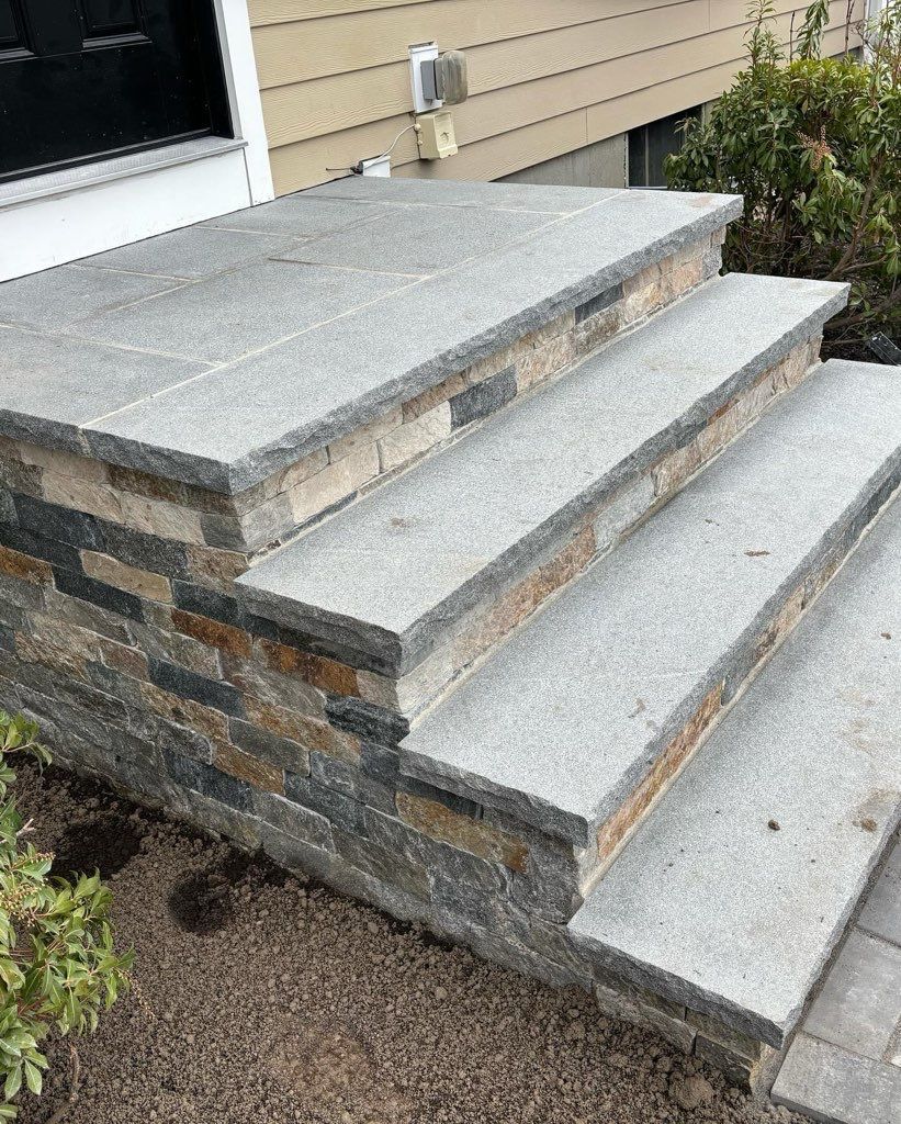 A set of stone steps leading up to a house.