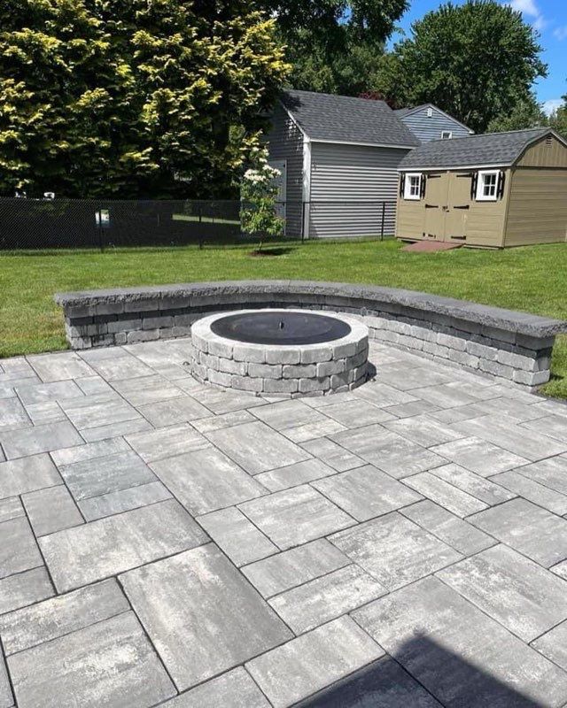 There is a fire pit in the middle of the patio.