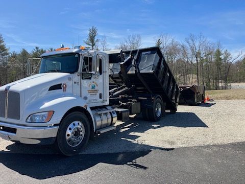 A dump truck is parked on the side of the road.