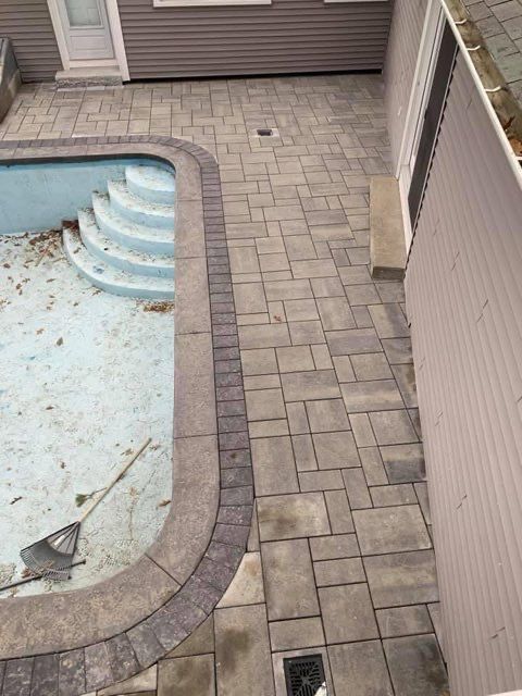 An aerial view of a swimming pool surrounded by bricks