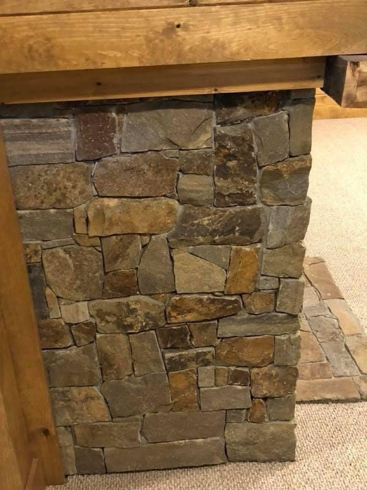 A close up of a stone wall with a wooden frame.