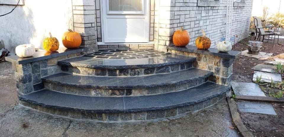 There are pumpkins on the steps of a house.