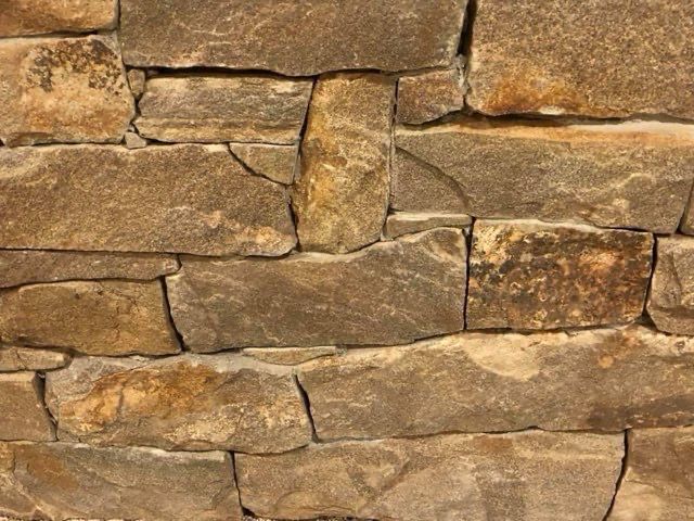A close up of a stone wall with a lot of bricks