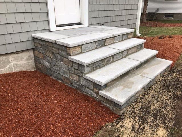 A set of stone steps leading up to a house.