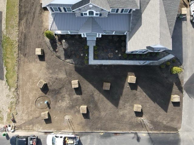 An aerial view of a house with boxes in front of it