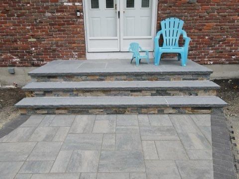 A blue chair sits on the steps of a house