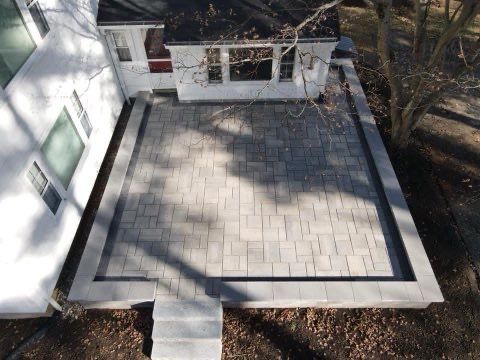 An aerial view of a patio in front of a house.
