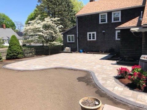 A large house with a patio in front of it.