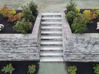 A stone wall with a set of stairs leading up to it