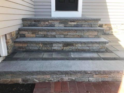 A set of stairs leading up to the front door of a house.