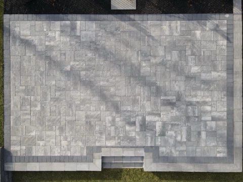 An aerial view of a stone patio with steps leading to it.