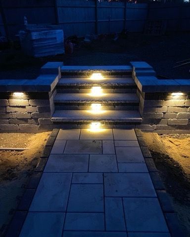 A set of stairs with lights on them at night.