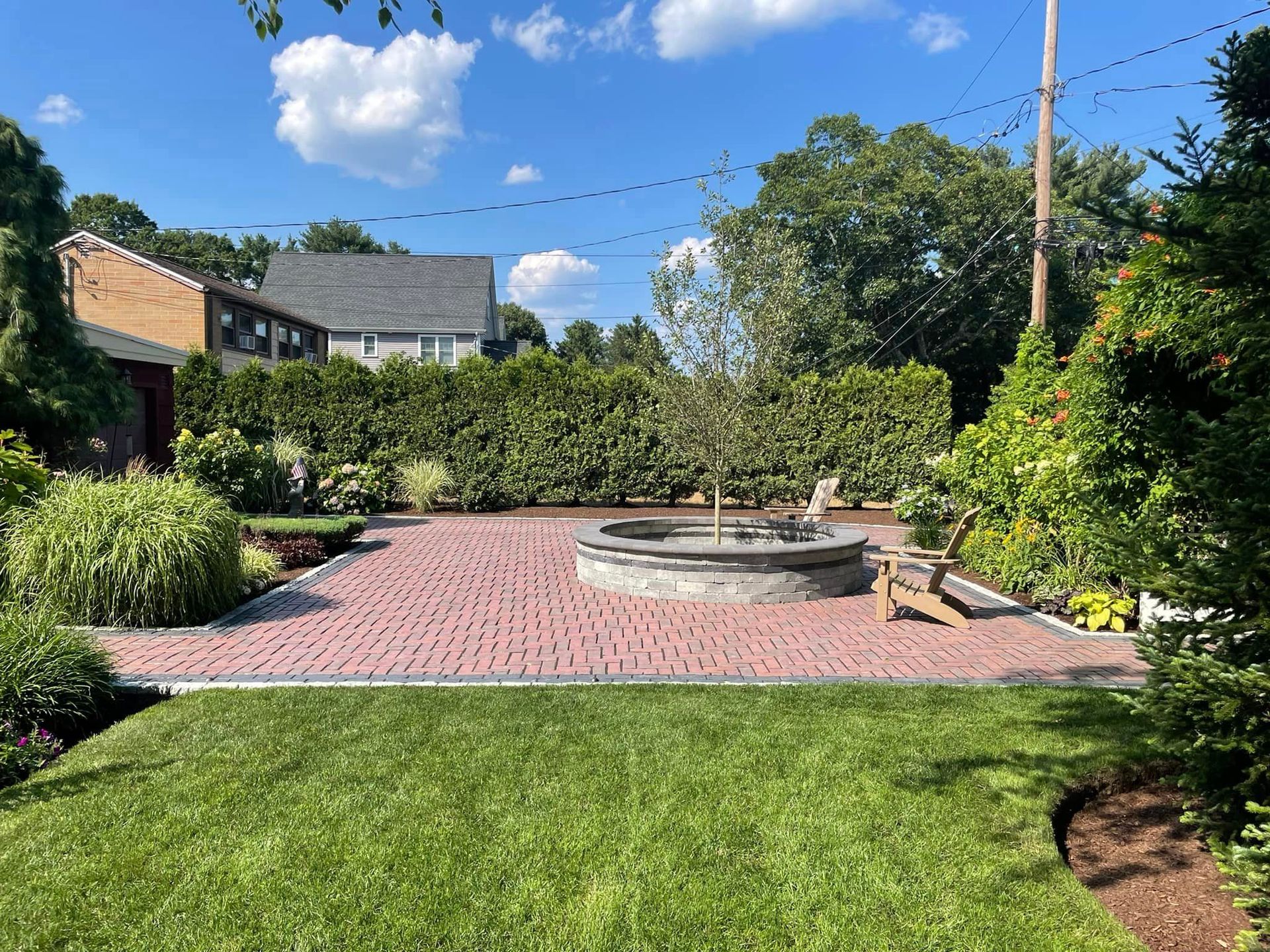 there is a fire pit in the middle of the yard .